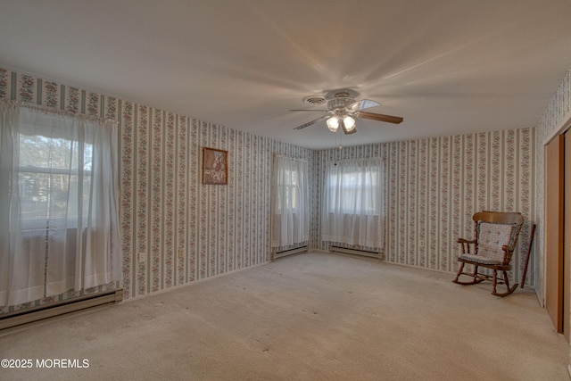 unfurnished room featuring a baseboard radiator, wallpapered walls, carpet, and a ceiling fan