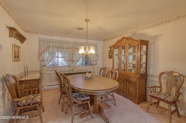 dining room featuring light colored carpet, a notable chandelier, and visible vents