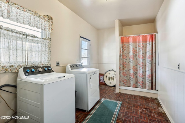 clothes washing area featuring laundry area, independent washer and dryer, and brick floor