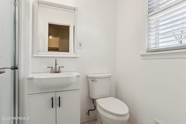 half bath featuring toilet and vanity