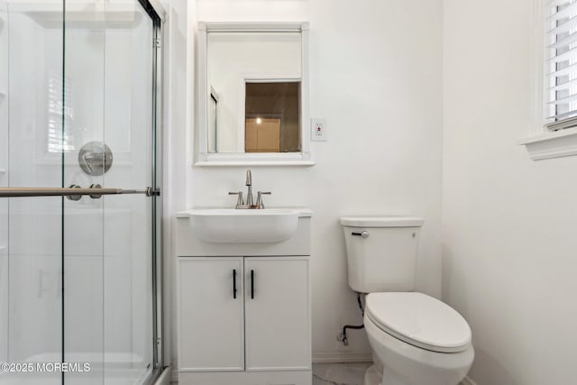 bathroom with toilet, marble finish floor, a stall shower, and vanity