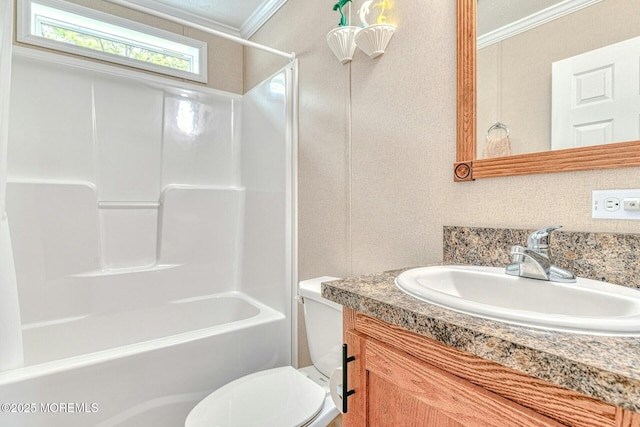 bathroom with toilet, bathtub / shower combination, ornamental molding, and vanity