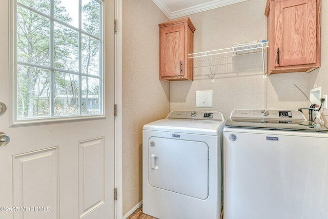 washroom featuring cabinet space, crown molding, and separate washer and dryer