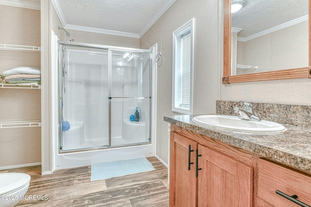 bathroom featuring wood finished floors, crown molding, and an enclosed shower