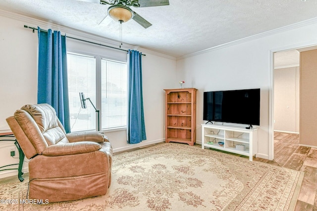 living area with a textured ceiling, crown molding, and wood finished floors