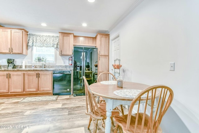 kitchen featuring black appliances, light brown cabinets, ornamental molding, and light wood finished floors