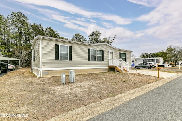 manufactured / mobile home featuring crawl space and driveway