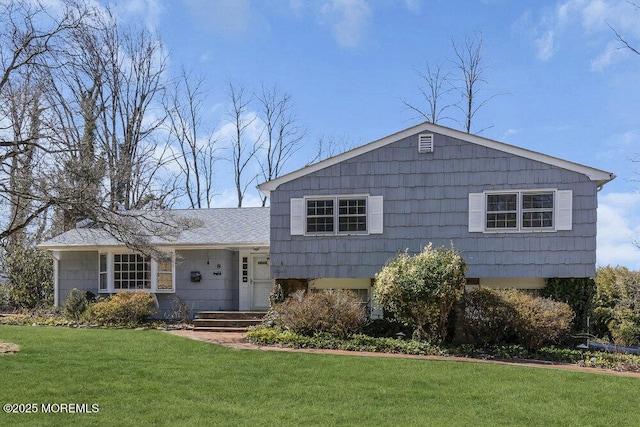 split level home featuring a front lawn