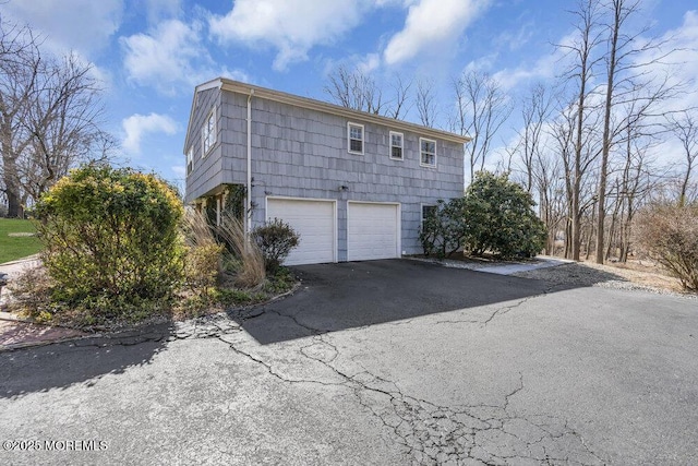 view of home's exterior with driveway and an attached garage