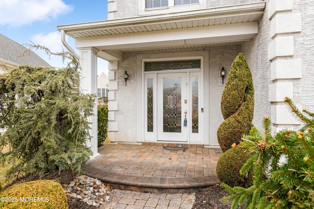 entrance to property featuring stucco siding