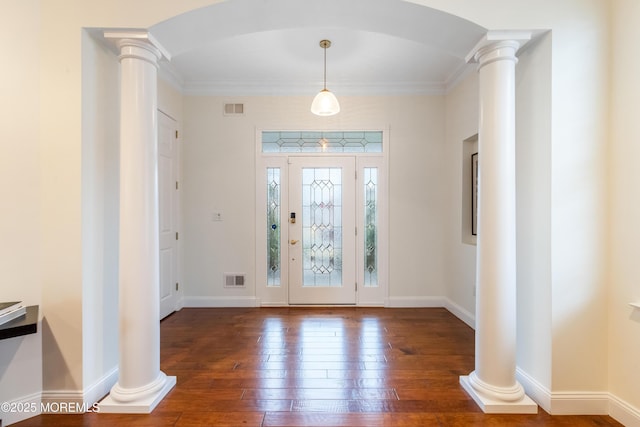 foyer entrance featuring ornate columns, wood-type flooring, and visible vents