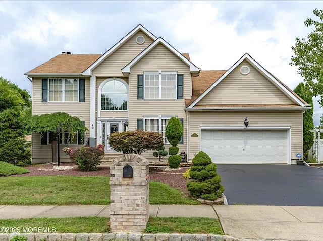 view of front of house with an attached garage and driveway