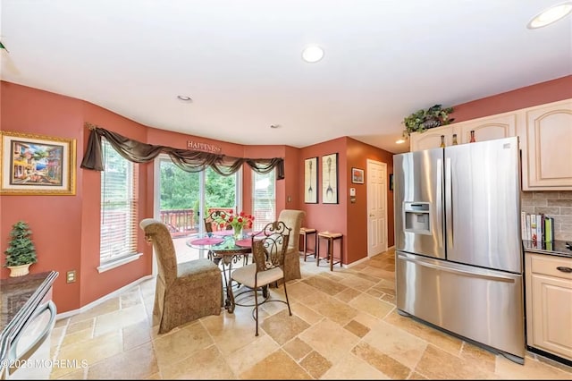 dining space with recessed lighting, baseboards, and stone tile flooring