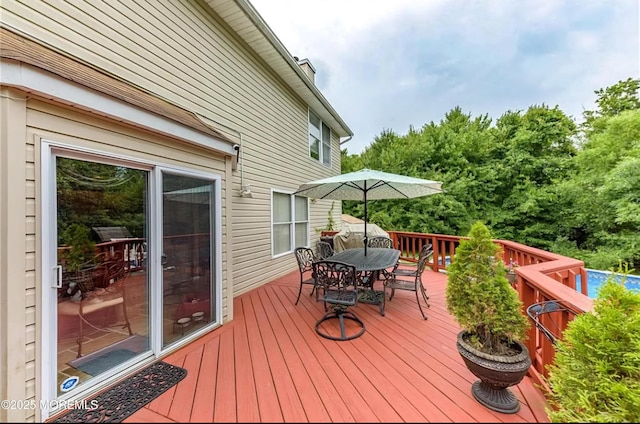 wooden terrace featuring outdoor dining space