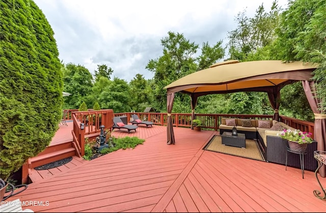 deck with a gazebo and an outdoor living space