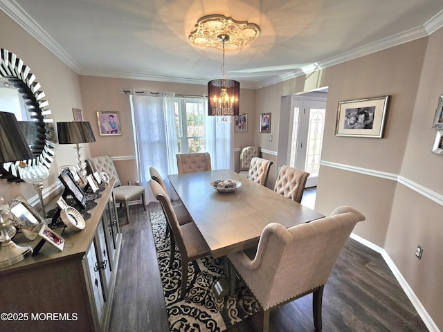 dining area featuring baseboards, dark wood-type flooring, a chandelier, and crown molding