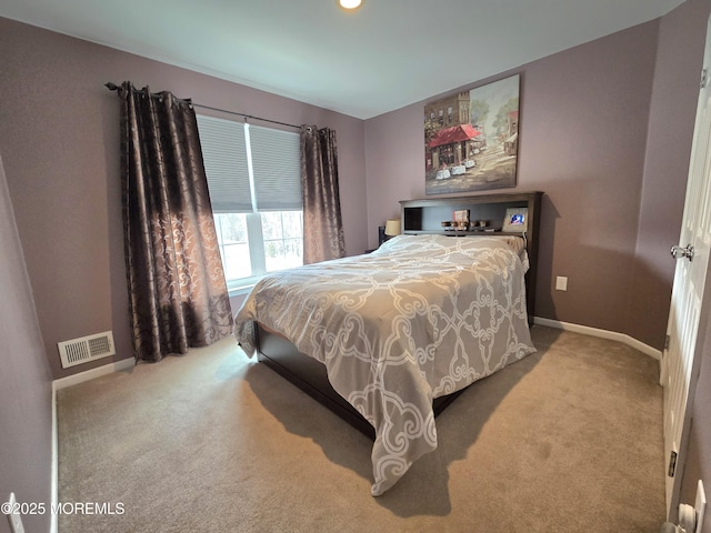 bedroom with visible vents, baseboards, and carpet