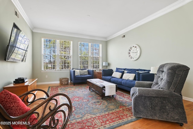 living room with baseboards, visible vents, wood finished floors, and ornamental molding