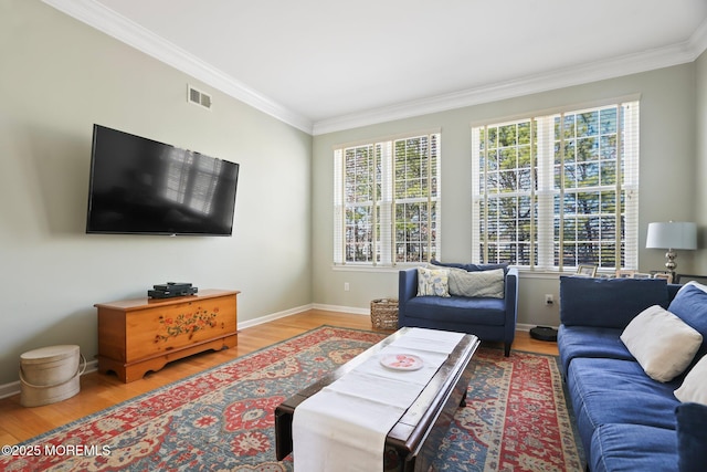 living area featuring ornamental molding, wood finished floors, visible vents, and baseboards