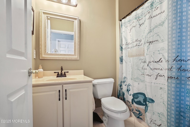 bathroom featuring curtained shower, tile patterned flooring, vanity, and toilet