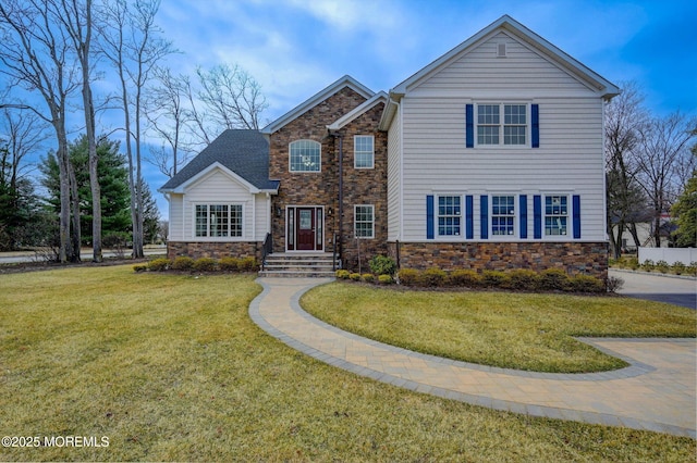 traditional home with stone siding and a front lawn