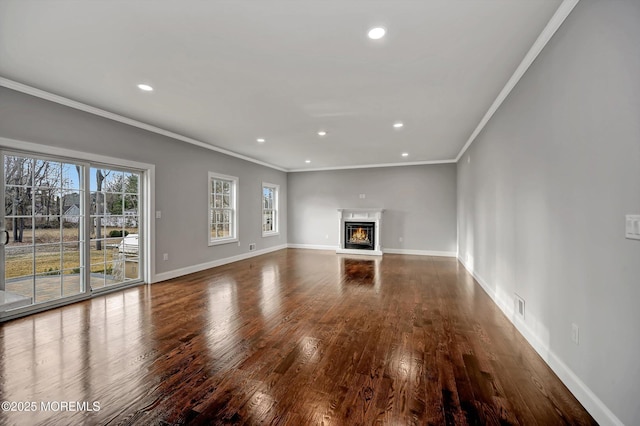 unfurnished living room with recessed lighting, baseboards, and wood-type flooring