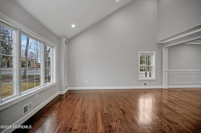 spare room with visible vents, baseboards, recessed lighting, wood finished floors, and high vaulted ceiling