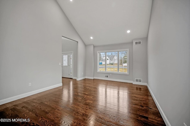 empty room featuring visible vents, baseboards, and wood finished floors