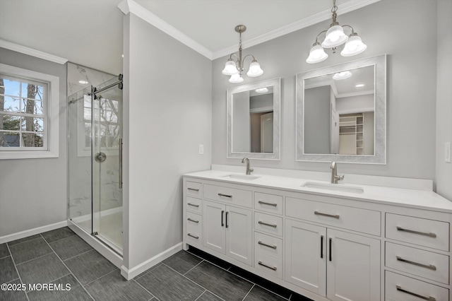 bathroom with a sink, a stall shower, and ornamental molding