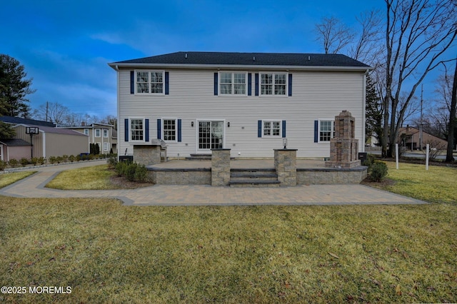 back of property with a yard and a patio area