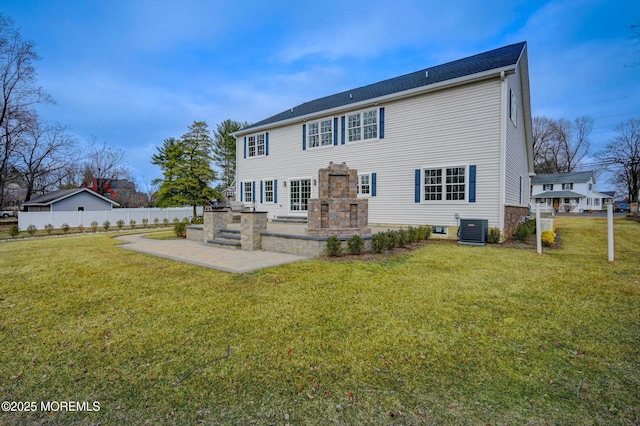 back of house featuring central air condition unit, a patio, a yard, and fence