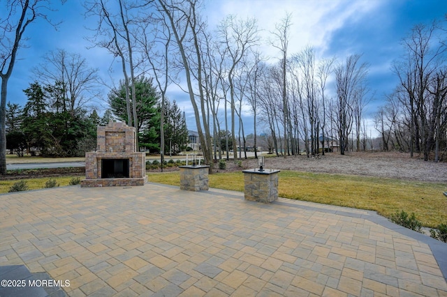 view of patio with an outdoor stone fireplace