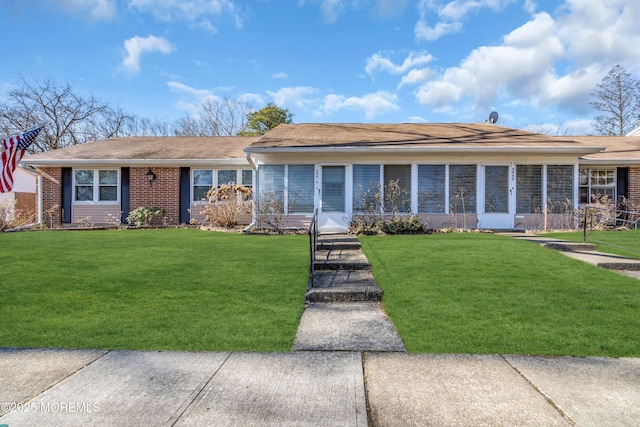 ranch-style home with brick siding and a front lawn