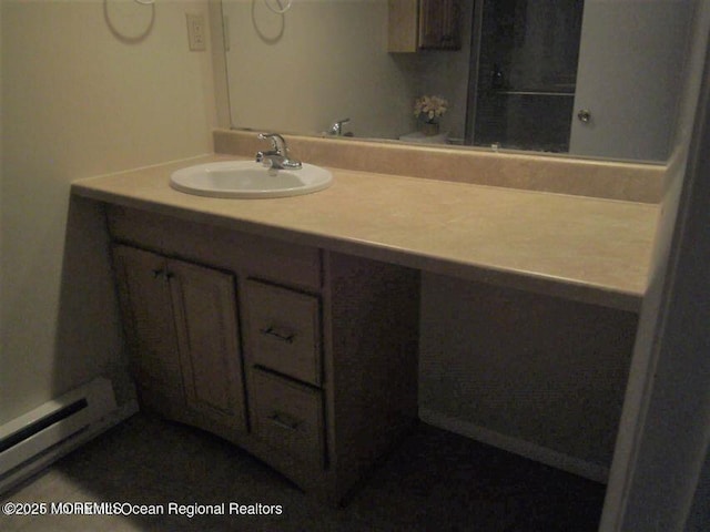 bathroom with vanity and baseboard heating