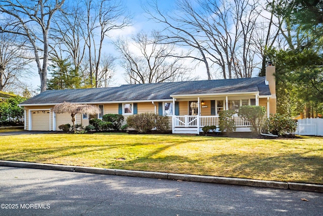 single story home featuring a garage, a chimney, covered porch, fence, and a front yard