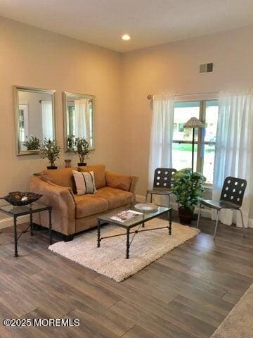 living room featuring visible vents and wood finished floors