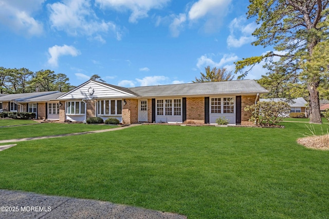 ranch-style home with brick siding and a front lawn