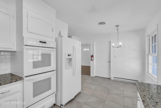 kitchen with visible vents, a notable chandelier, white cabinetry, white appliances, and baseboard heating