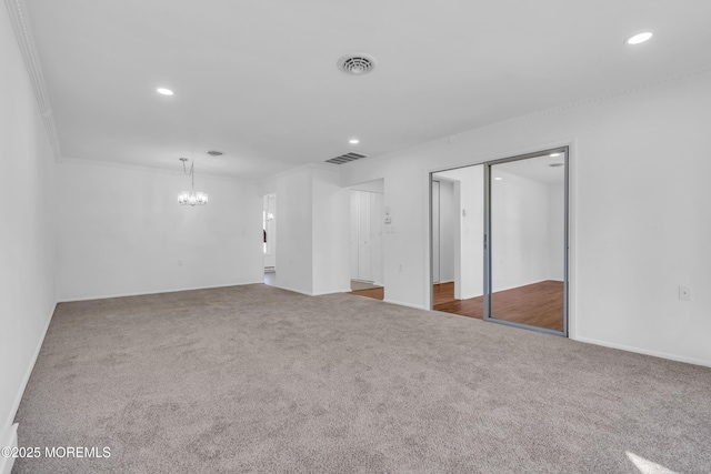 interior space featuring a chandelier, visible vents, recessed lighting, and carpet