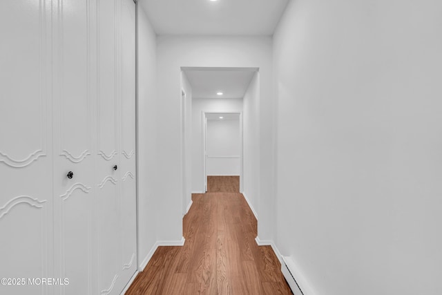 hallway with baseboards and wood finished floors