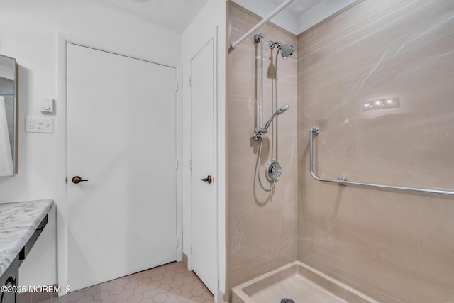 full bathroom with vanity, a stall shower, and tile patterned flooring