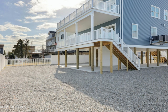 back of property featuring stairs, central AC, a patio area, and fence