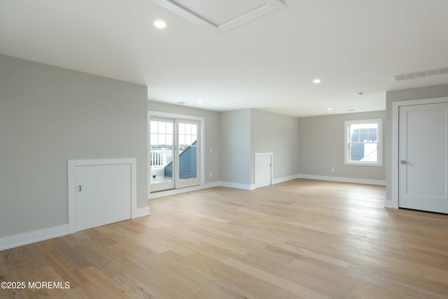 unfurnished room with light wood finished floors, visible vents, a wealth of natural light, and recessed lighting