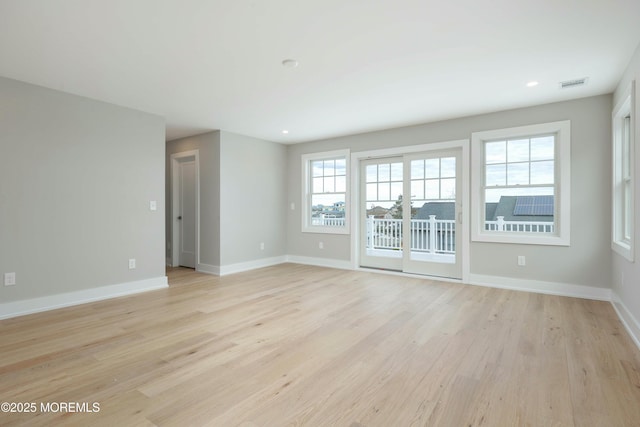 empty room featuring recessed lighting, light wood-type flooring, visible vents, and baseboards