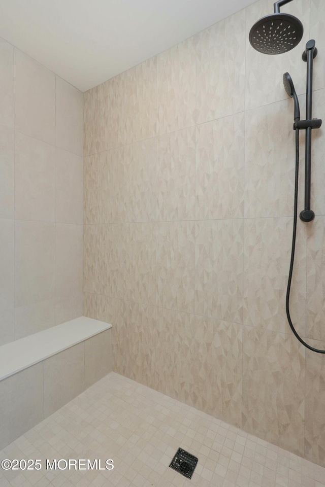 bathroom with a tile shower