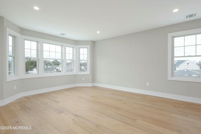 empty room with plenty of natural light, visible vents, and recessed lighting