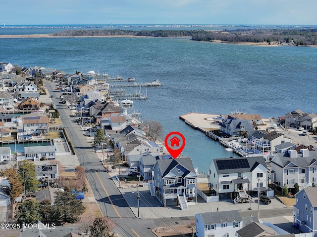 drone / aerial view featuring a water view and a residential view