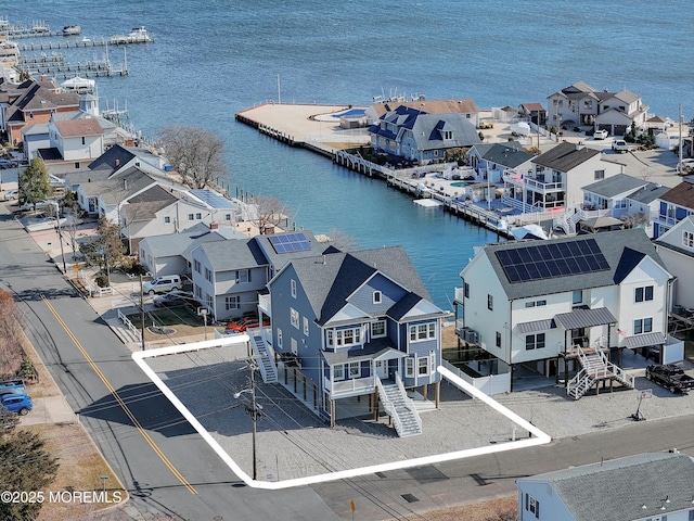 drone / aerial view with a residential view and a water view