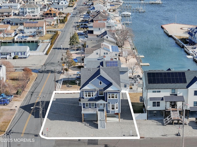 birds eye view of property featuring a water view and a residential view