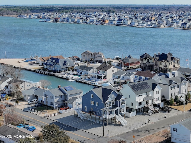 drone / aerial view featuring a water view and a residential view